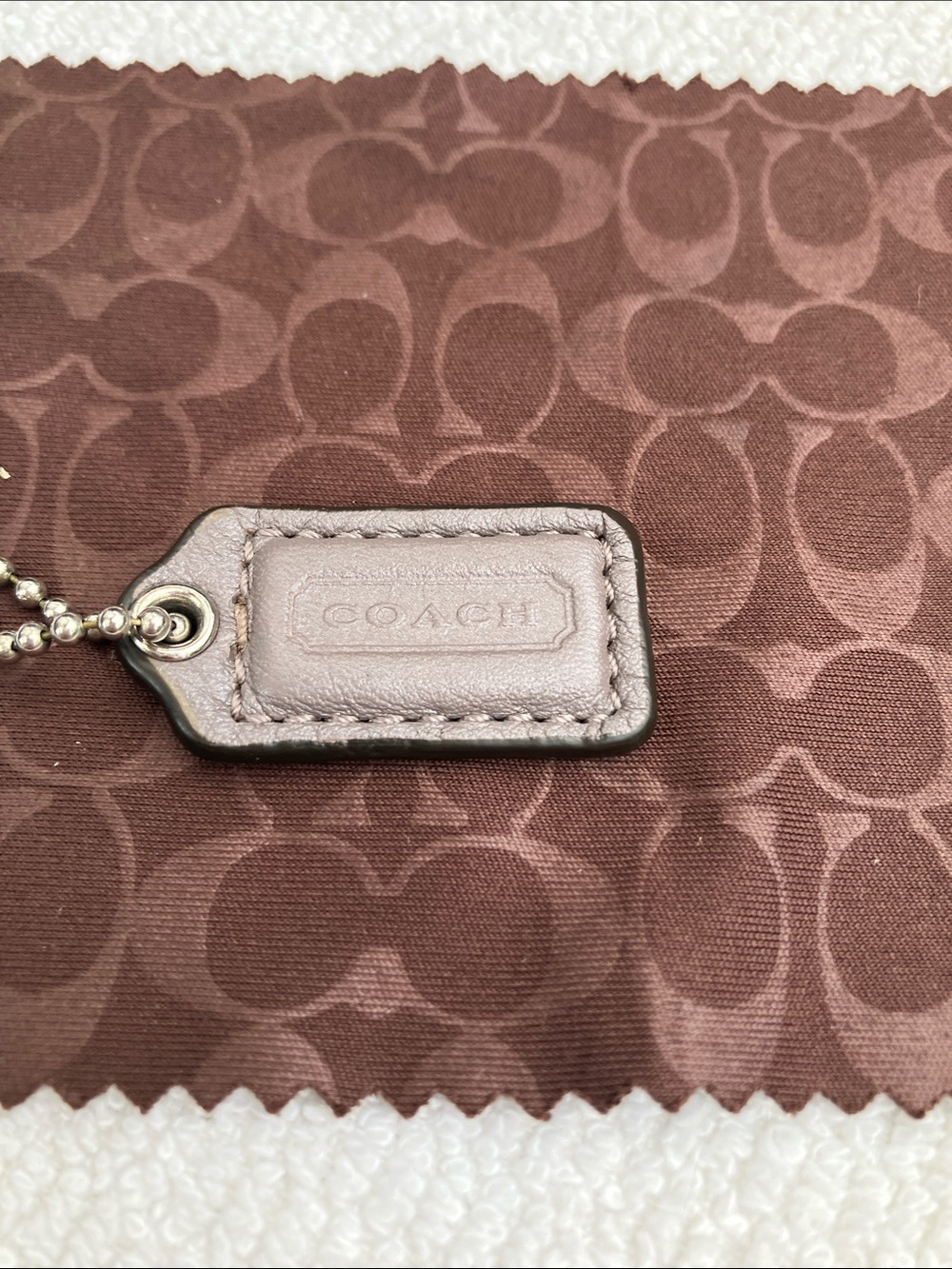 Coach small 1” gray pewter color leather hang tag with stitching
